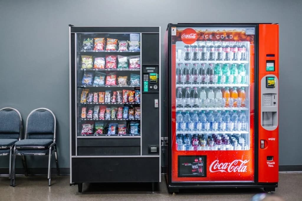 A snack machine and a drink machine side by side in a waiting area