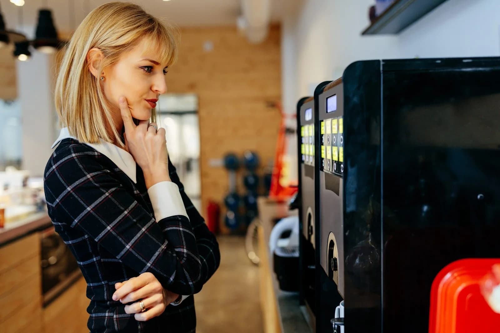 A woman choosing at a coffee machine